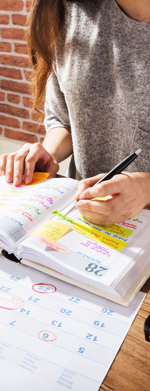 Business owner writing goals in a planner